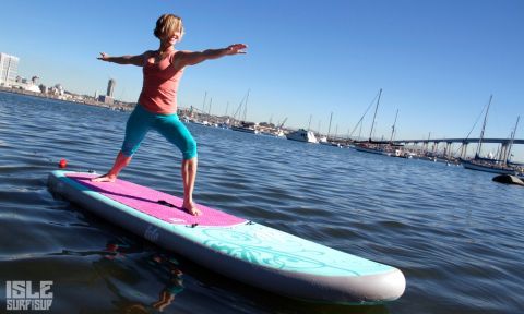 Helen Cloots demonstrates the Warrior 2 Yoga Pose on her Isle Surf and SUP inflatable paddle board.