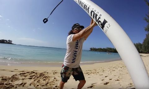 Todd Caranto of Pau Hana SUP demonstrating how to lift a stand up paddle board.