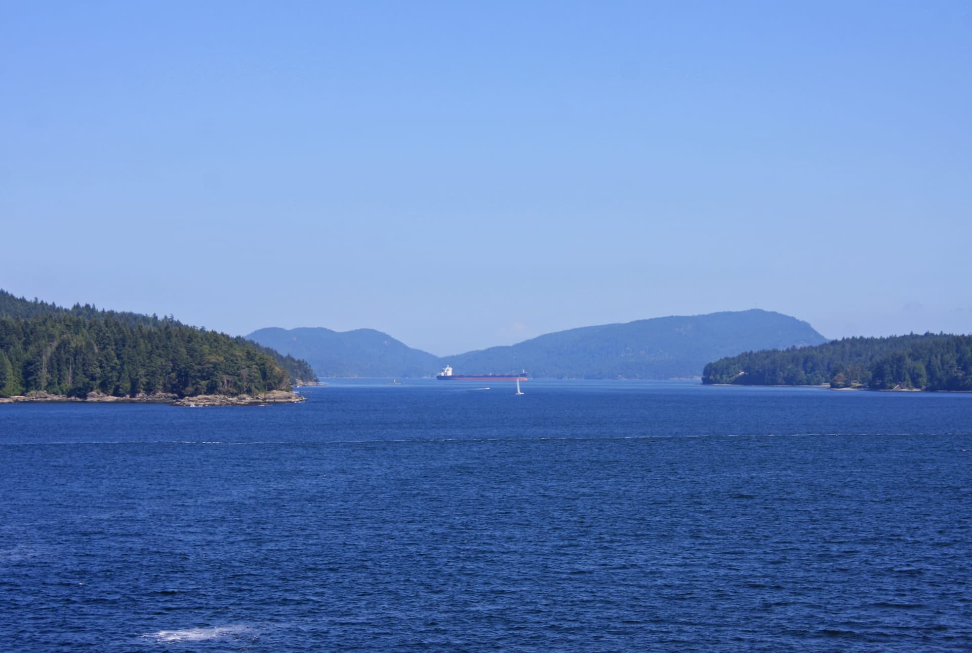 Forested Gulf Islands seen across calm water from Vancouver Island