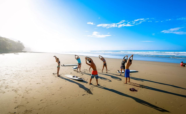 sup-yoga-beach-stretch