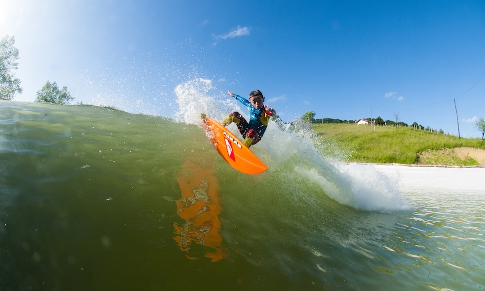 boy surfs wavegarden