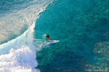 _BenThouardSeaCo_Manu_Bouvet_alone_on_wave_in_the_Tuamotu_Aerial_Shot_of_Tuamotu_atoll_French_Polynesia_July_2011