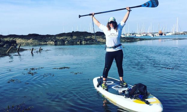 A visibly stoked Sian Sykes after finishing her circumnavigation of Anglesey. | Photo via: Sian Sykes