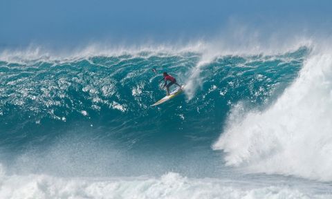 Kai Lenny takes off on a bomb at Sunset. | Photo Courtesy: Waterman League