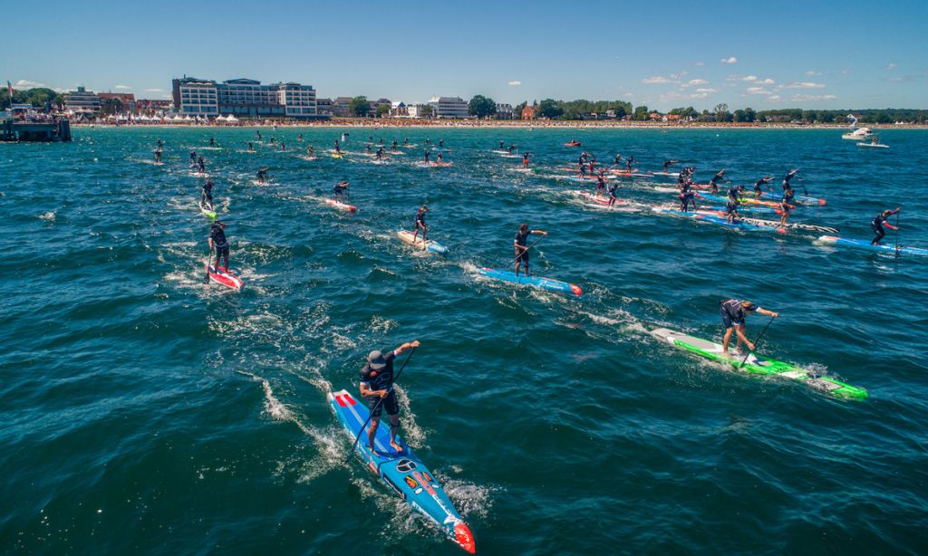 Boothy (blue board) and Lincoln (green) leading the field in Scharbeutz. | Photo Courtesy: Paddle League / Georgia Schofield