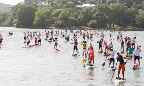 Executive Director and Founder of The Flatwater Foundation, Mark Garza (in grey) leads group of paddlers to dock.