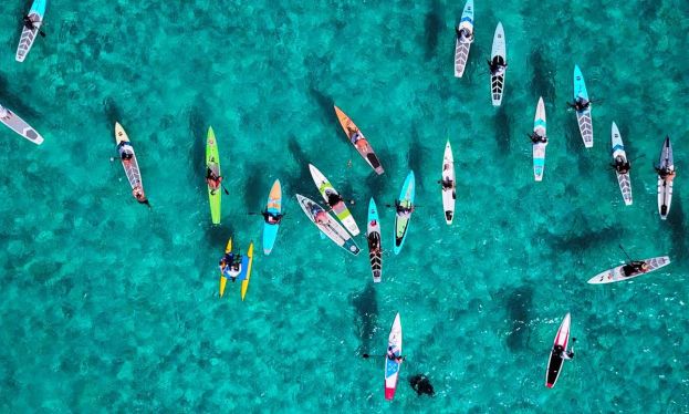 Paddlers assemble in Bimini, in preparation for the 80-mile Crossing For A Cure to Lake Worth Beach, Florida. Jimmy Buffett has signed on as an Advisor to the Board of Piper’s Angels Foundation. | Photo Courtesy: Crossing for a Cure