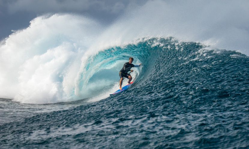 Hawaii’s Zane Schweitzer pulls into a barrel at Cloudbreak with his signature Aloha smile. | Photo: ISA / Sean Evans