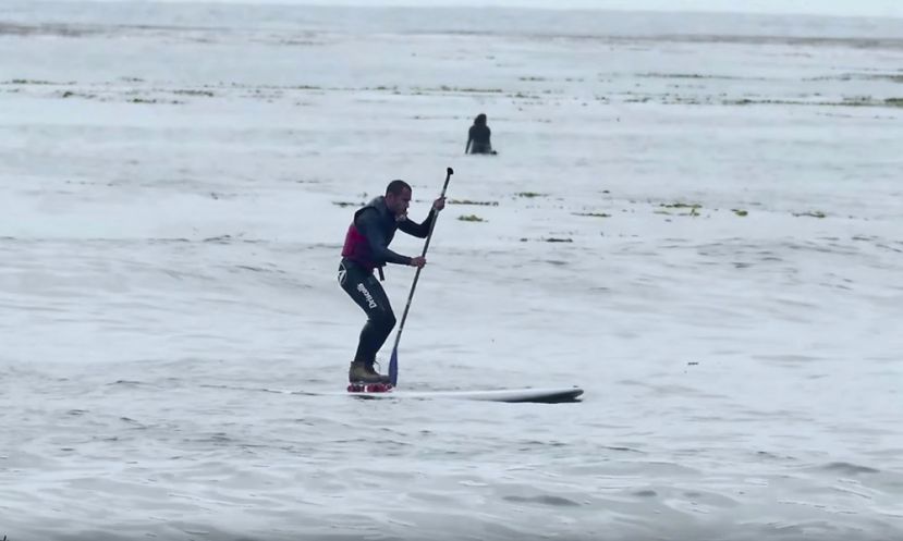 Tyler Fox, attempting to paddle board while on roller skates.