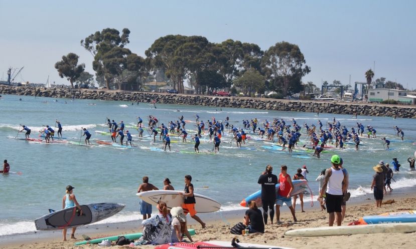 Paddlers running into the water at the 2017 Pacific Paddle Games